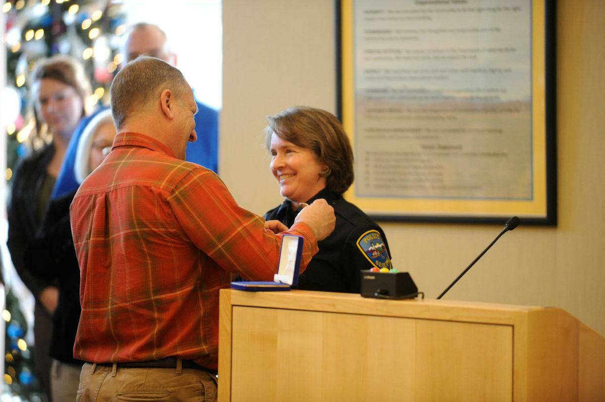 Sequim Gazette file photo by Matthew Nash/ Pat Crain pins the Sequim police chief badge on his wife Sheri Crain on Friday, Dec. 16, 2016, after she was sworn into the position. She’ll officially retire on March, 2024.