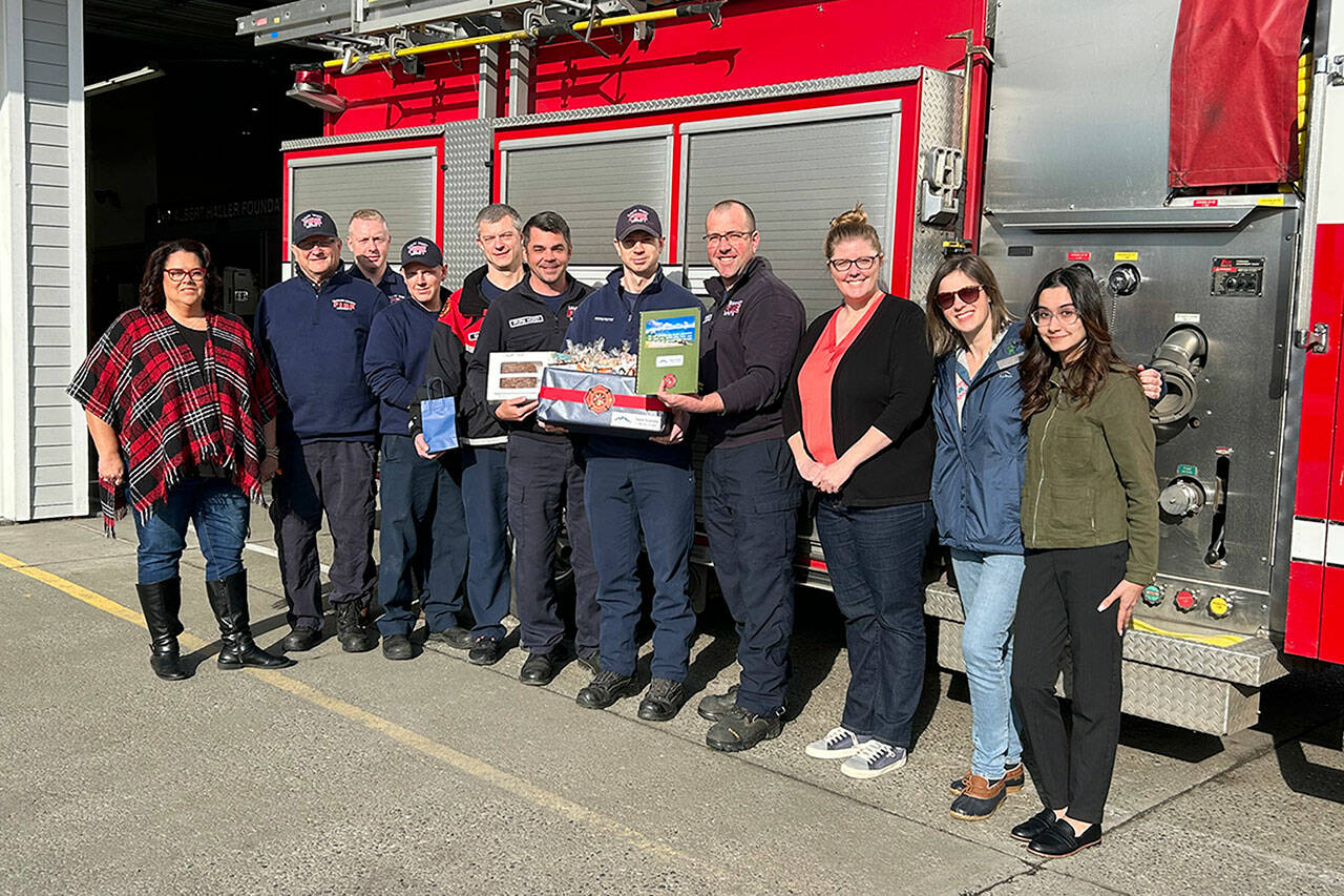 Sequim Gazette photo by Matthew Nash
Clallam County Fire District 3 Firefighters on A shift at Station 34 gather with Sequim Association of Realtors representatives for a donation of goodies and gift cards to local coffee businesses on Feb. 13. Real estate professionals donated to local first responders for Valentine’s Day.