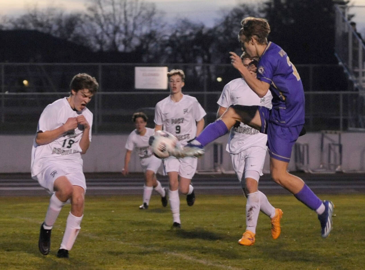 Sequim Gazette photo by Matthew Nash / Sequim’s Preston Kurtze puts a boot to the ball while surrounded by Port Angeles defenders’ Grant Butterworth, Jackson Wyall, Myles Close, Aurelio Wilson-Rojero and Caleb Lagrange (obscured) during the Wolves’ 4-2 win on March 14.