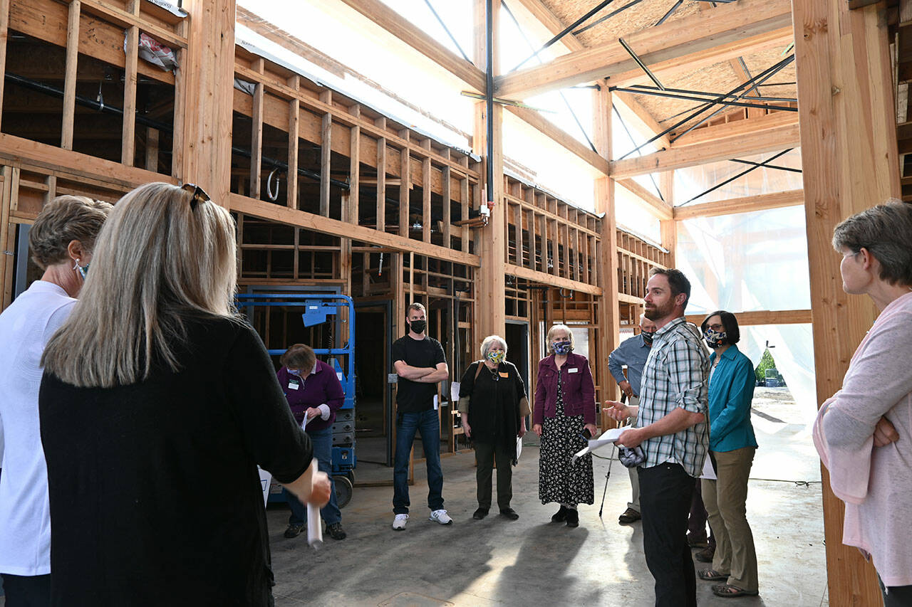 Sequim Gazette file photo by Michael Dashiell / Dungeness River Audubon Center director Powell Jones, right, helps guide a tour of the center’s renovation to Sequim Sunrise Rotary Foundation board members in 2021.