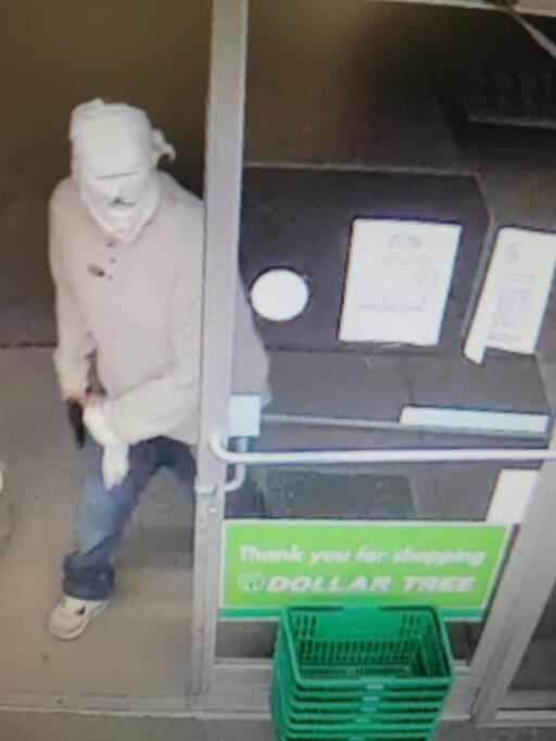 Image courtesy of Clallam County Sheriff’s Office / Surveillance video footage shows a man brandishing a gun at the Dollar Tree store in Port Angeles on March 18.