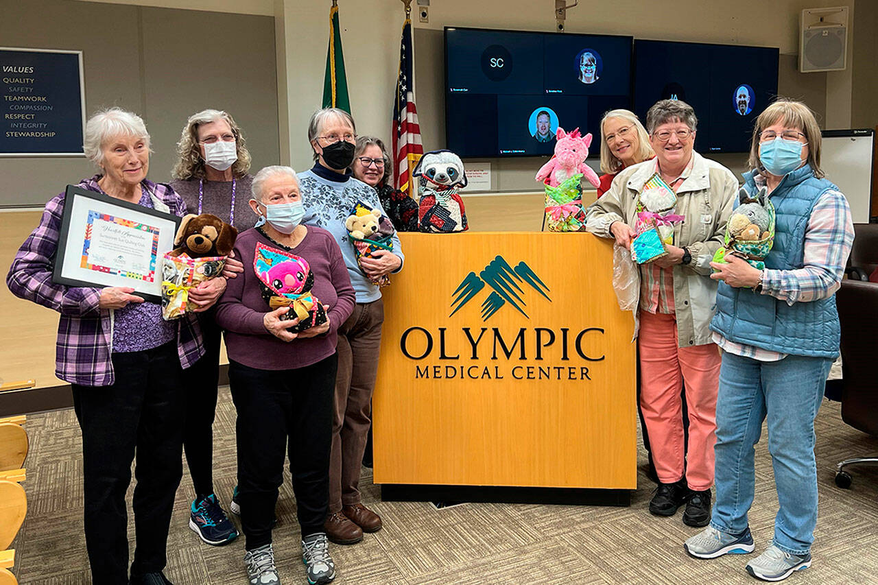 Photo courtesy Olympic Medical Center
Sunbonnet Sue Quilt members were honored by Olympic Medical Center on March 6 for their contributions of thousands of Joy Quilts to child patients since 2000. Some of the participating quilters are, from left, Loretta Bilow, Jean Marie McDonald, Bernadette Shein, Chris McDonald, Jan Johannessen, Bonnie Cauffman, Marianne Ballard, and Stephanie Swensson.