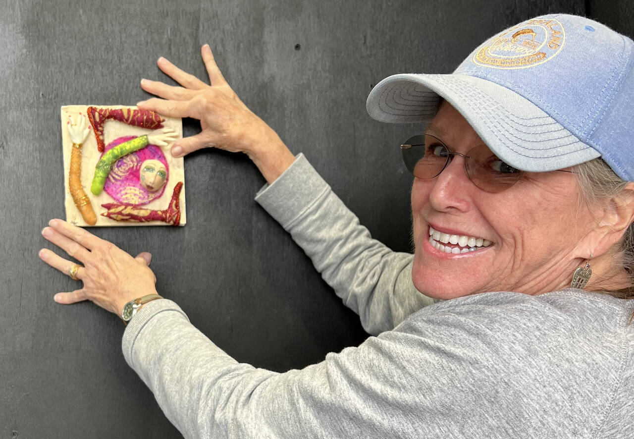 Photo courtesy of Peninsula Fiber Artists
Port Townsend artist Annie Karl hangs her “Transporter Malfunction” miniature during installation of the “Funky Ladies” 24/7 exhibit at 675 Tyler St., Port Townsend.