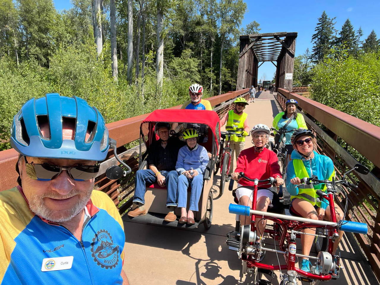 Photo courtesy of Sequim Wheelers / Sequim Wheelers, pictured here on the historic Railroad Bridge near the Dungeness River Nature Center, prep for a ride on the Olympic Discovery Trail. The nonprofit’s season begins in May, and has an open house for potential new volunteers on April 20 at the River Center, and a new volunteers orientation on April 25, also at the River Center.