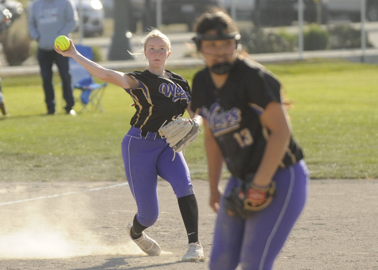 Sequim Gazette photo by Michael Dashiell / Sequim third baseman Ava Ritter throws out a Bremerton runner in an April 23 Olympic League match-up in Sequim. In the foreground is SHS pitcher Taylee Rome.