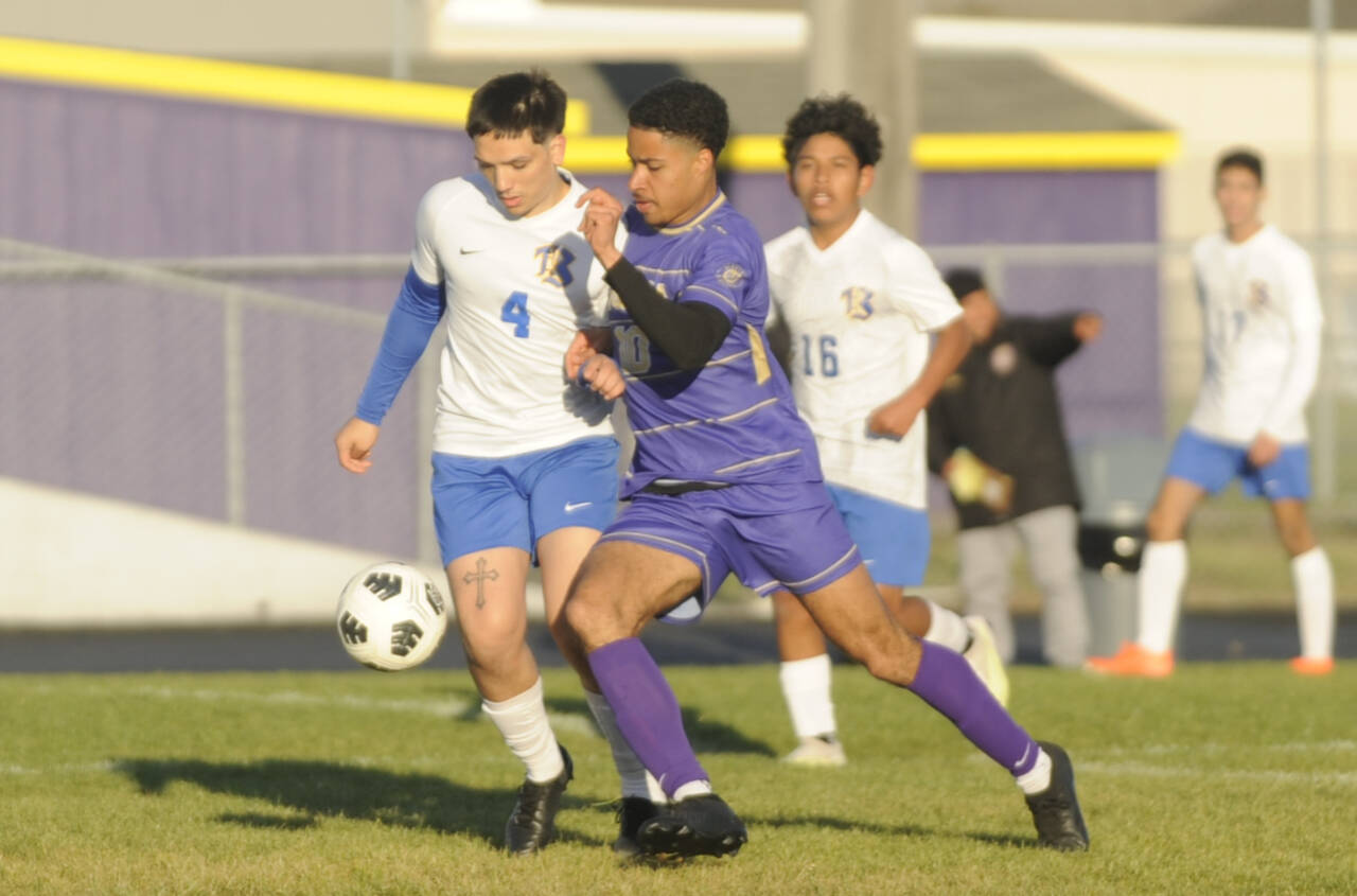 Sequim Gazette photo by Michael Dashiell / Sequim’s Mekhi Ashby, center, breaks through the Bremerton defense in the first half of the Wolves’ 4-3 home loss on April 30. Defending the play are Bremerton’s Evan Harvey (4) and Luis Funez Ramos (16).