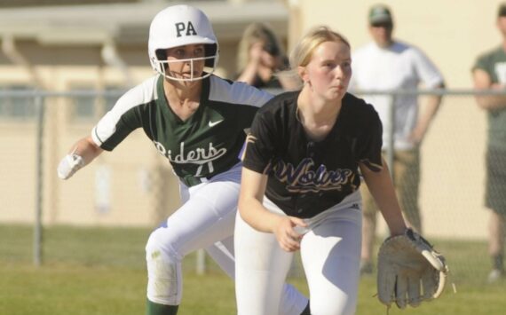 Sequim Gazette photo by Michael Dashiell / Port Angeles' Ava-Anne Sheahan takes a lead off first base behind Sequim first baseman Ava Ritter on May 10.