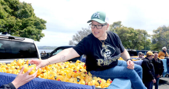 Dave Logan for the Olympic Peninsula News Group/
Port Angeles Mayor Kate Dexter is one of several local people who helped pluck a winning duck from a pickup truck on Sunday at Port Angeles City Pier. There was 36 ducks to be plucked from six Wilder Toyotas.