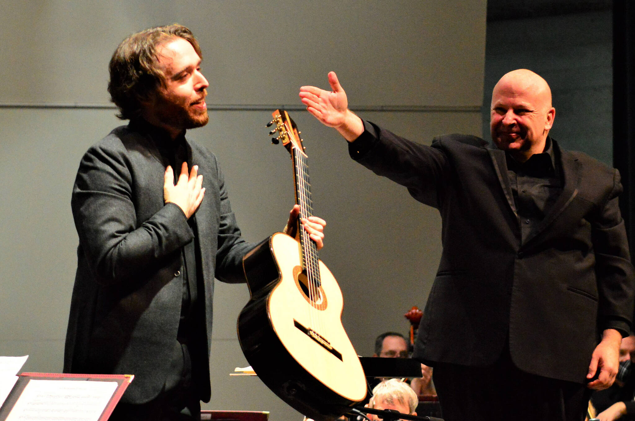 Photo courtesy Diane Urbani de la Paz
Guitar soloist Colin Davin, left, takes a bow following his performance with the Port Angeles Symphony and conductor Jonathan Pasternack in 2021. Davin returns for two solo recitals this week in Port Angeles and Sequim.