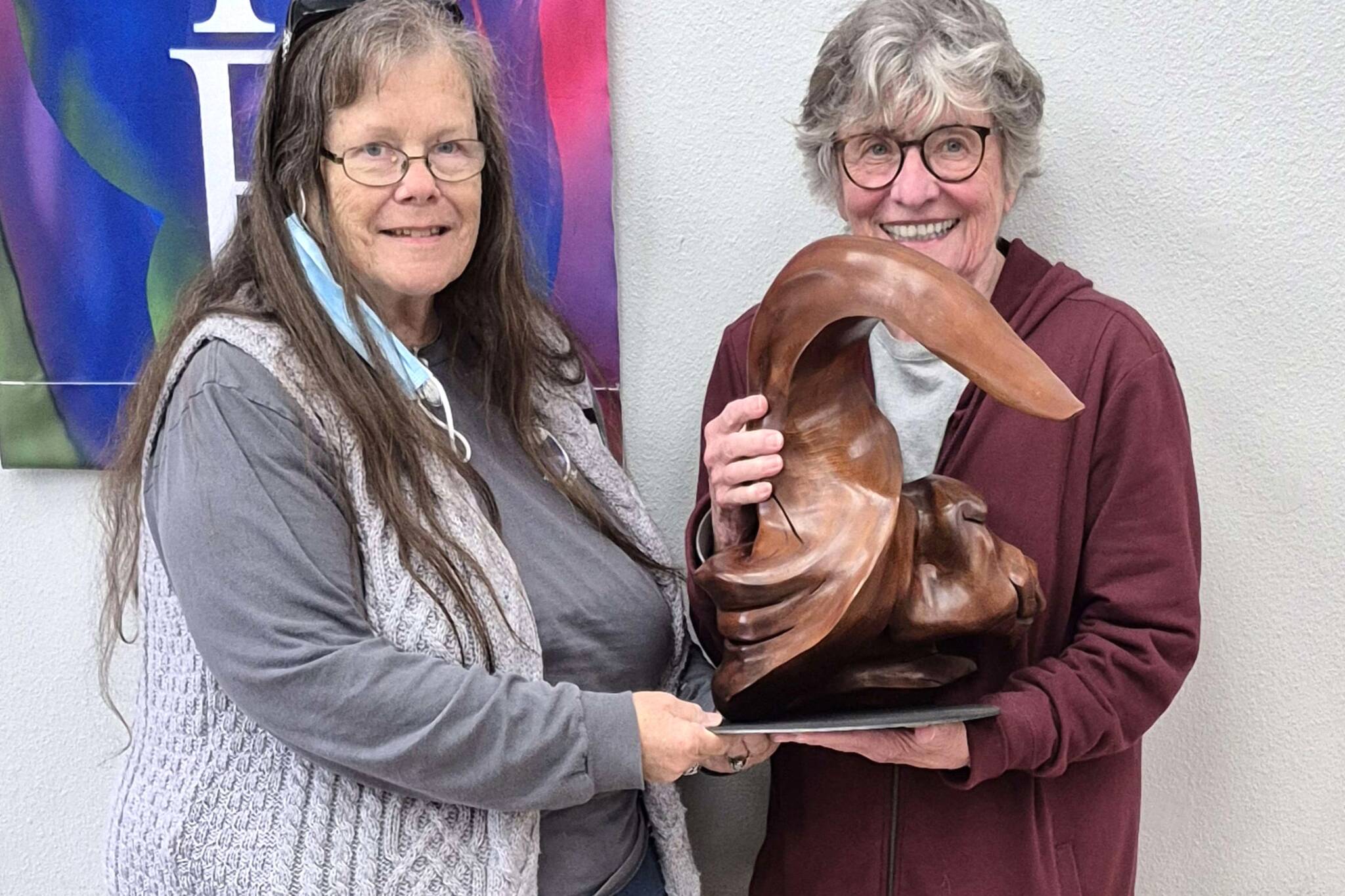 Photo courtesy of Jill Steele
Kathy Bachman, left, president of Olympic Driftwood Sculptors, presents Bertha Cooper with the sculpture she won after her ticket was drawn at the group’s October meeting. Several members worked to create the piece.