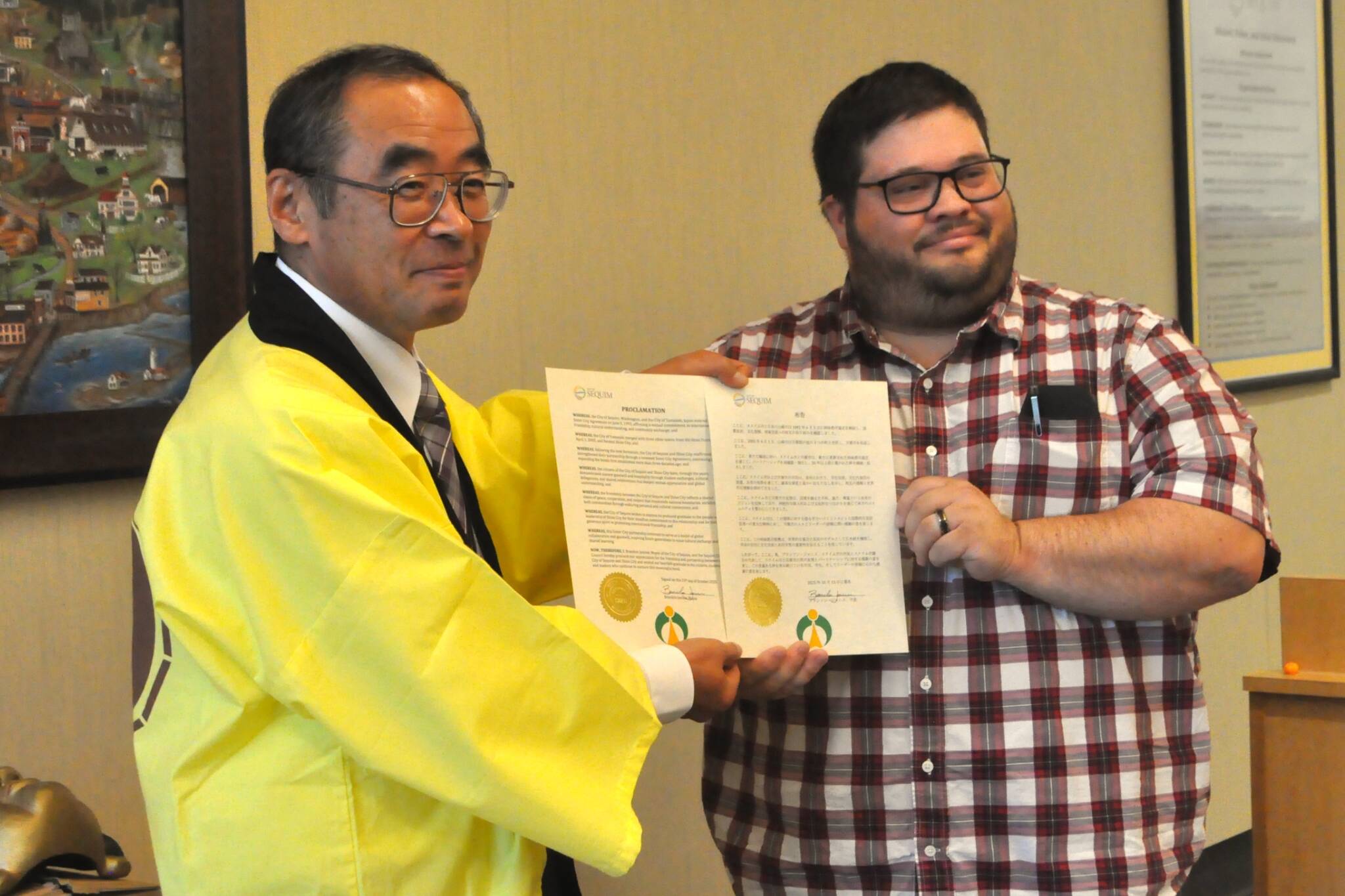 Sequim Gazette photo by Matthew Nash/
Shiso City Deputy Mayor Kenji Tomita and Sequim Mayor Brandon Janisse show a proclamation read on Oct. 13 in Japanese and English during the Sequim City Council meeting.