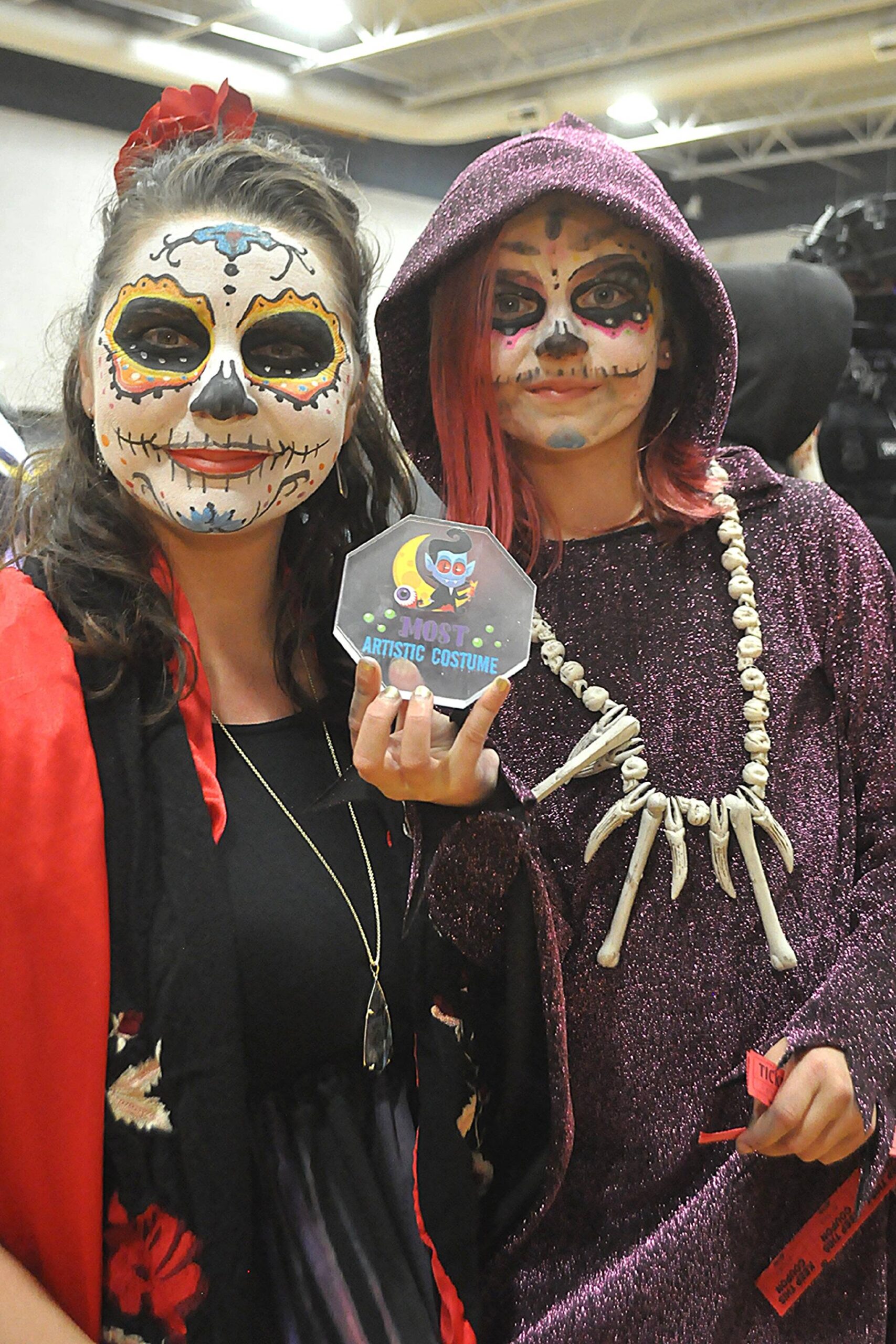 Sequim Gazette photo by Matthew Nash
Evelyn Zdzieblowski, 8, proudly shows the medallion she won for “Most Artistic Costume” at the Sequim Boys & Girls Club’s Halloween Bash on Saturday, Oct. 25. Evelyn and her mom Maria dressed for Day of the Dead following Evelyn’s suggestion.