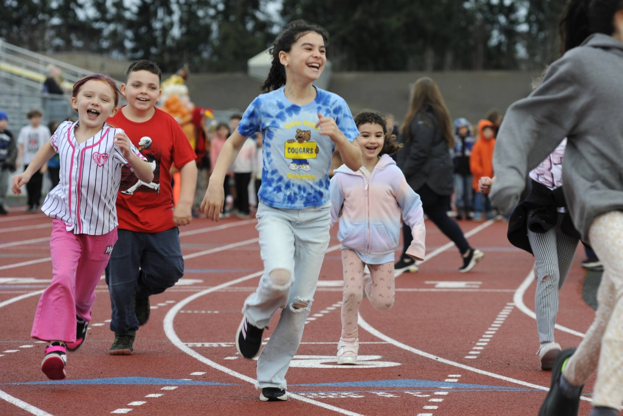 Sequim Gazette photos by Matthew Nash
Third grader Thea Thomas, center, is all smiles with classmates and her sister Essie at the start of Helen Haller Elementarys Turkey Trot fundraiser on Nov. 27.