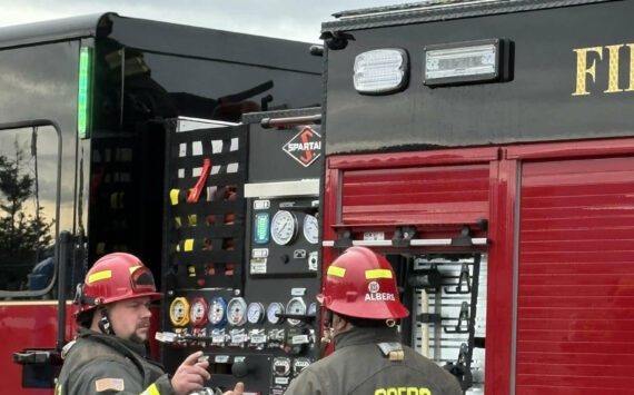 Photo courtesy CCFD3
Captains Jeff Albers and Travis Anderson with Clallam County Fire District 3 discuss training on a new fire engine while Firefighter Ryan Hueter loads a hose.