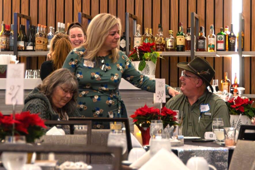 Sequim Gazette photo by Monica Berkseth
Sequim Valley Lions Club marketing chair Cely Alhaddad greets attendees at the Saturday, Dec. 6 event at 7 Cedars commemorating the nonprofit’s 70th anniversary.