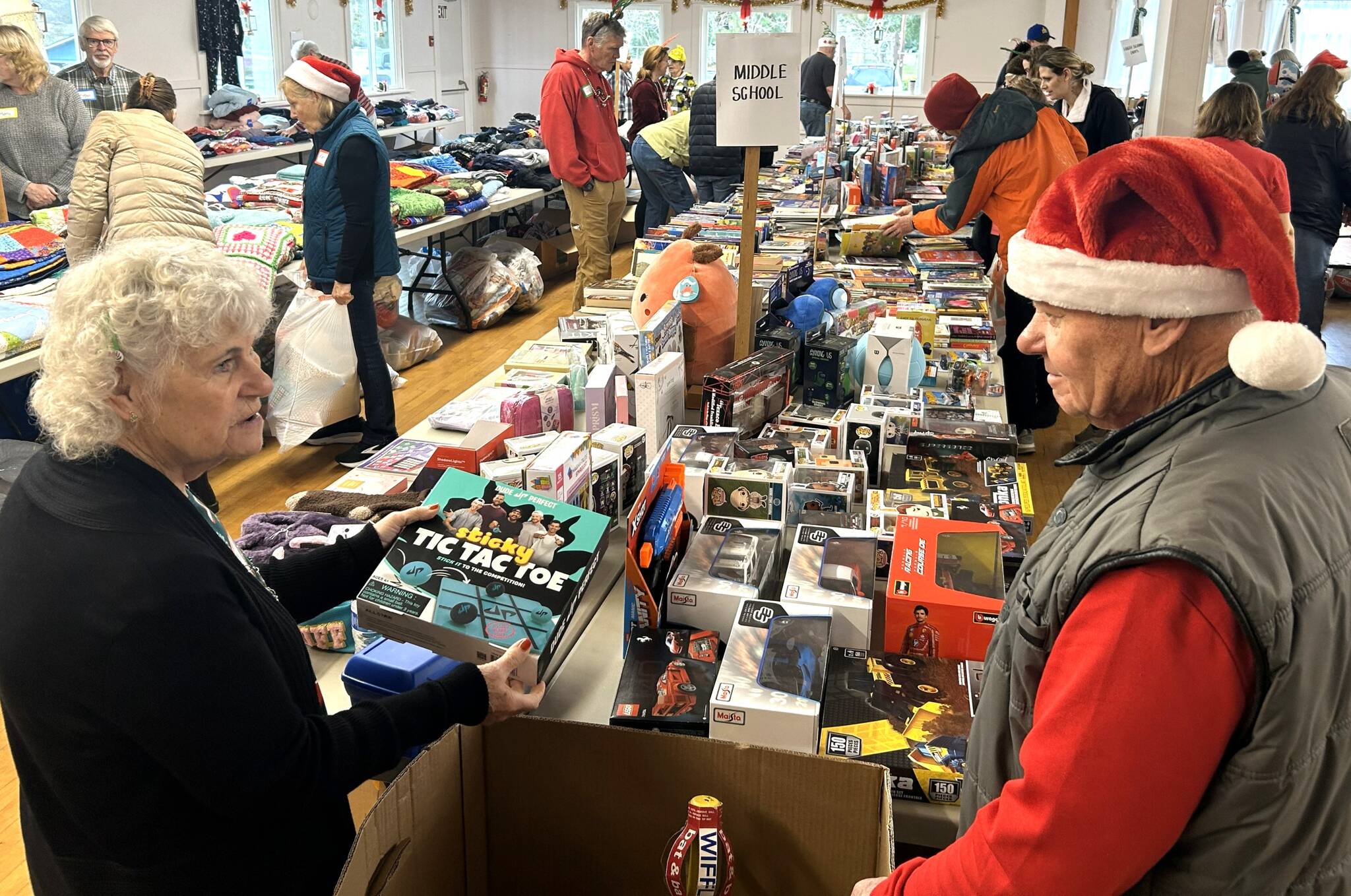 Sequim Gazette photos by Matthew Nash
For the fourth year, Nancy and Ivor Garbush volunteer at Toys for Sequim Kids looking to help families find the right gifts for their children. Giving out toys to kids, you cant beat that! Nancy said.