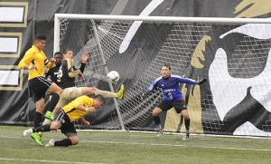 Peninsula goalkeeper Nick Johnson dives to deflect a shot as the Pirates take on Walla Walla last week.