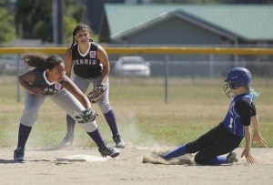 Sequim shortstop Jayla Julmist puts the tag down on an East Jefferson County baserunner as teammate/second baseman Kailynn Lopez looks on. Sequim topped East Jefferson 13-3 on June 25.