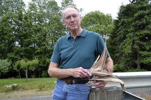 Don Berger holds fellow driftwood sculptor Cliff Peterson's art piece that he plans to finish for him by July 15 and the start of the Olympic Driftwood Sculptors' annual Lavender Weekend show. Peterson asked Berger to finish it for him due to health issues so that he could give it to his health provider.