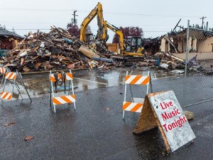 Crews with We Dig It begin taking down the burned out building on Oct. 30 at 820 W. Washington St. that formerly housed Baja Cantina and Sequim Consignment Co.