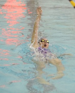Sydnee Linnane powers to a first-place finish in the 100 yard backstroke. She is close to qualifying for state