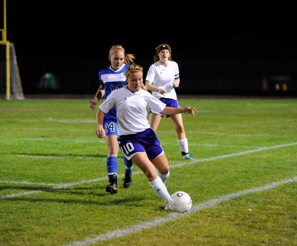 Chloie Sparks keeps the ball inbounds and away from an Olympic player on Oct. 9.