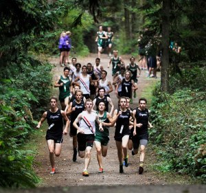 Sequim runners surround competitors at their home meet on Oct. 8 at Robin Hill Park. The Wolves took second-sixth places for the boys.