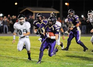 Sequim’s Brandon Stamper runs for a big gain as Sequim knocks off Port Angeles 49-6 on Oct. 16