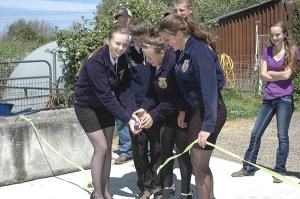 Sequim High School students belonging to the Future Farmers of America program cut the ribbon on their new composting facility June 11. From left