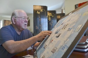 Richard Tarbuck looks over a display he made a few years ago centered on stamps from around the world featuring Antarctica. His display features more than 15 countries’ stamps.