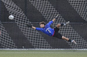 Peninsula goalkeeper Nick Johnson dives to make a stop against Whatcom on Sept. 23.