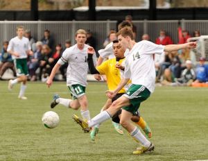 Sequim’s Christian Salas (3) battles for the ball with a  Port Angeles midfielder as the Wolves  fall to the host Riders