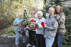 Members of the Holiday Nature Mart committee each hold examples of the crafts that will be available at the upcoming event. From left