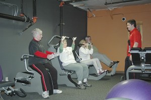 Fitness director Kenny Hall at Anytime Fitness guides Arlene McClelland