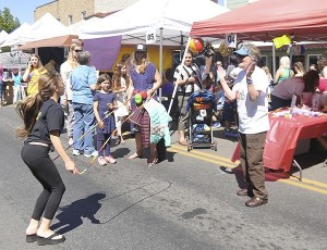 Bertha Cooper (far right) helps count jump roping at the Healthy Community Coalition booth at the Kids Fair