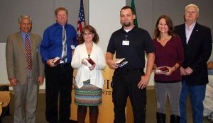 Olympic Medical Center’s Board of Commissioners and CEO Eric Lewis recognized four employees at the Sept. 3 work session: (from left) Kendal Wake