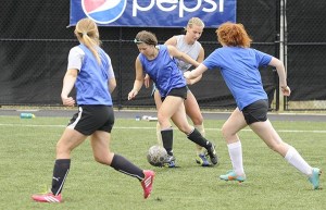 Sequim's Abigail Hansted works past Heidi Vereide as Lisa Radford