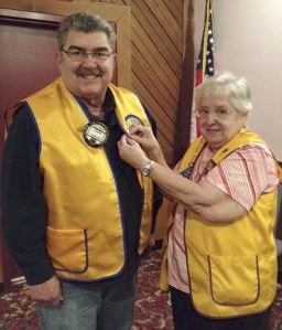 Sequim Lions Club secretary Betty Wilkerson pins Frank Cimino in recognition of his 35 years with Lions Club.