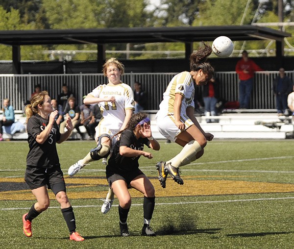 Peninsula College’s Kai Mahuka (right) gets her head in the game with teammate Taylor Berg (11) assisting as the Pirates take on Saint Martin’s University at the Rumble in the Rainforest soccer exhibition on April 25. Peninsula hosted several top college and pro teams from the region in the second-annual event.