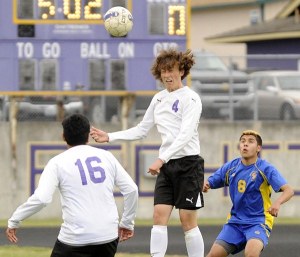 As teammate Josh Gonzalez (16) looks on