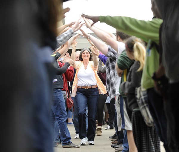 Sequim High School students and staff give Dan and Janet Peterson a 'go tunnel' send-off last week; the Petersons are retiring.