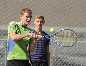 Eli Berg keeps his eye on a backhand return as teammate Matthew Richards looks on.
