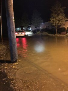 Water rushes onto Seventh Avenue on the evening of April 7. City officials estimate about 500