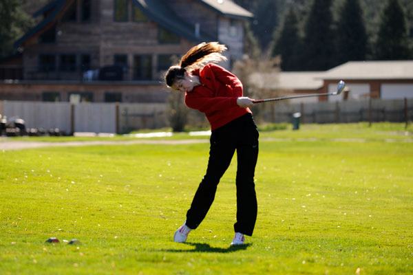 Sequim’s Alex McMenamin tees off against Klahowya on March 12.