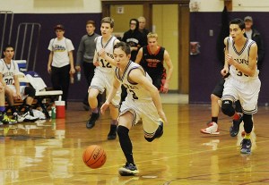 Sequim's Dustin Bates leads a fast break as Sequim clobbers Port Townsend on Dec. 15.