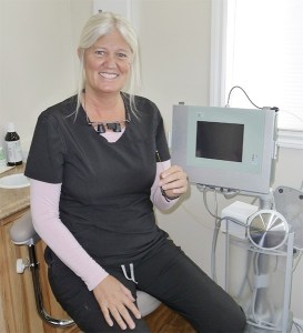 Judy Carroll shows the tiny camera that’s part of a periscope she uses to see bacteria hidden below the gum line in periodontal disease.