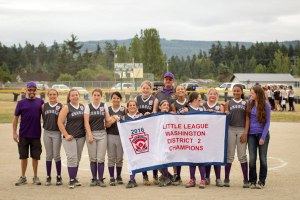 Sequim Little League’s all star girls majors softball team celebrates a District 2 title last week. They include (from left) coach Brad Teel