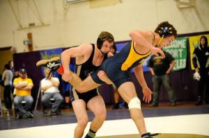 Sequim’s Kevyn Ward makes a last-second move on a Forks wrestler at the All Comers Tournament’s on Jan. 30. He advances to regionals this weekend after a second-place finish at 160 pounds.