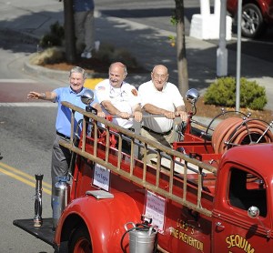 Clallam County Fire District 3 chiefs wave to the crowd at Clallam County Fire District 3’s centennial celebration parade in August. They are