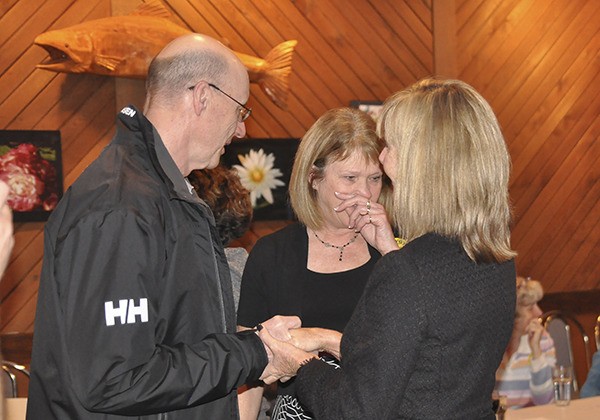 Dave Mattingley of Citizens for Sequim Schools talks with Sequim school staffers Karen Sande and Valorie Knieper Tuesday evening after learning the Sequim School District's $154 million bond proposal failed.